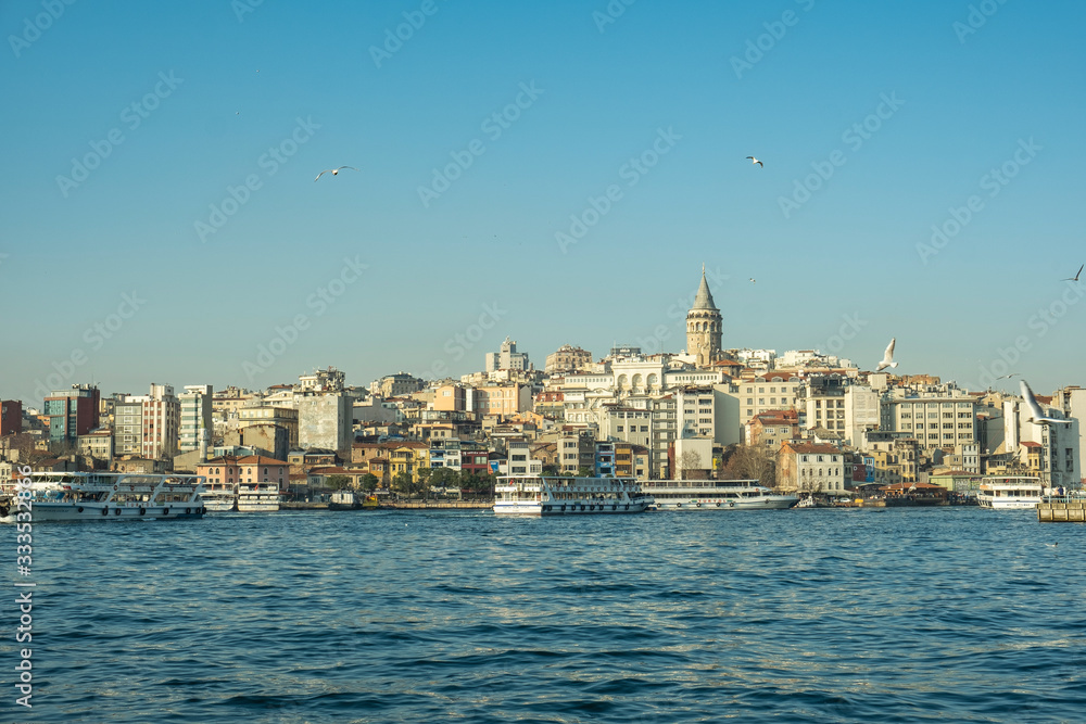 Cityscape of Galata Tower, steamboat and Bosphorus in Istanbul / Turkey - March 2020: Galata Tower and Bosphorus is very popular and famous place for tourist in istanbul. Seaside of Golden Horn.