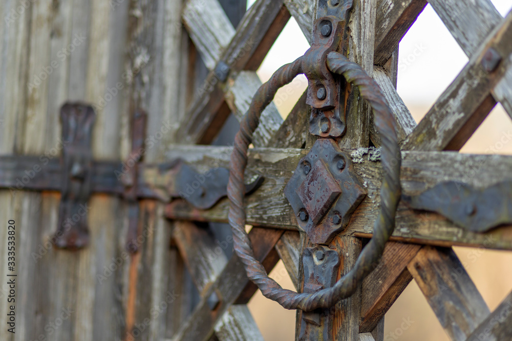 wooden gate with metal fastenings and metal ancient locks wooden gate with metal fastenings and metal ancient locks