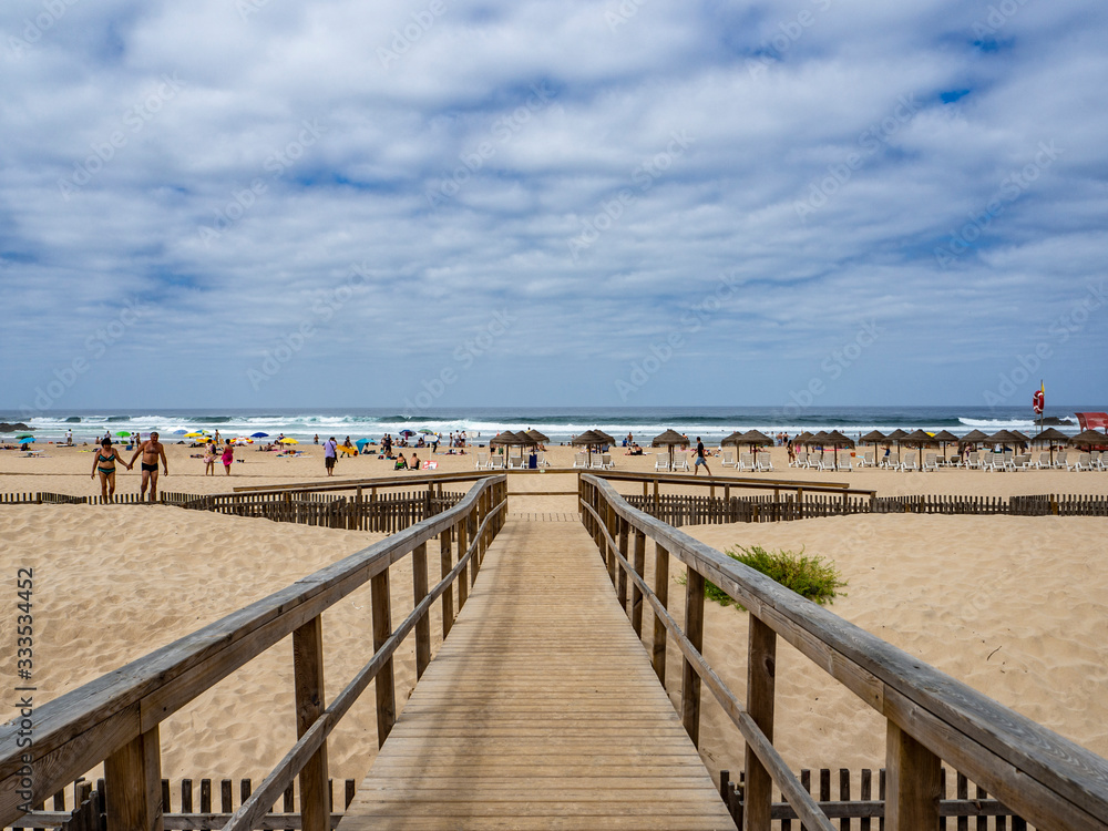 Camino de madera entre las dunas que conducen a la playa en el Algarve portugués