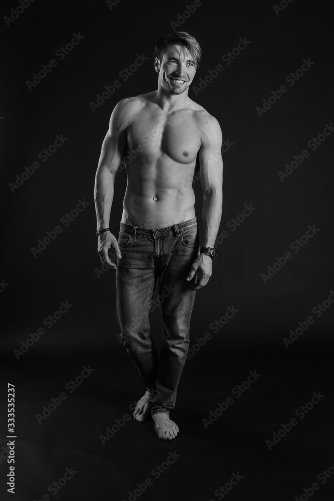 black and white studio shoot of strong athletic man on dark background black and white studio shoot of strong athletic man on dark background