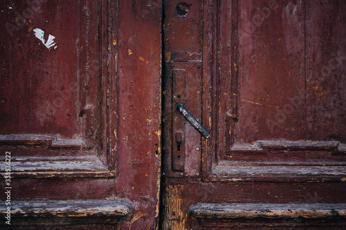 Red door textured rustic wood and handle © Justin