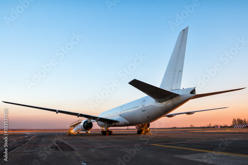 Bilde på lerret White wide body passenger aircraft at the airport apron in the evening light