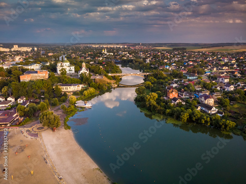 Beautiful evening top view of the river, city, central beach, churches, bridge. Bila Tserkva. photo