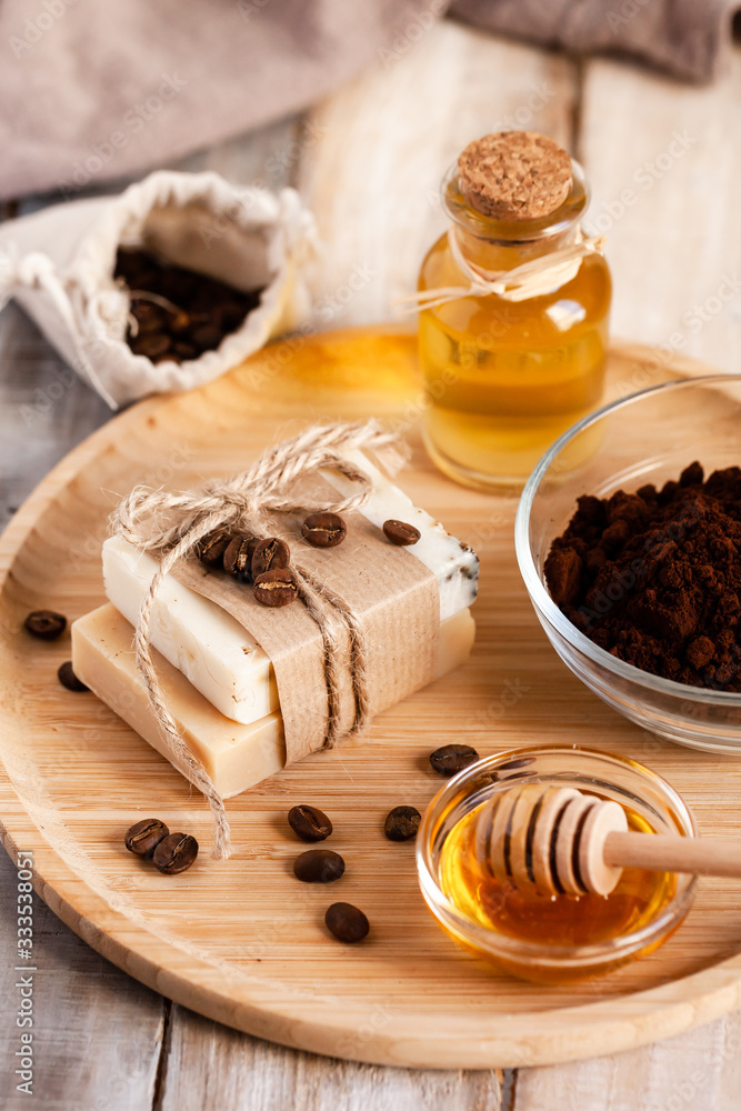 Concept of home beauty care and natural organic ingredients in cosmetology. Handmade soap to wash hands Coffee, honey, oil, oat for gentle skin peeling and moisturizing. Wooden background closeup Concept of home beauty care and natural organic ingredients in cosmetology. Handmade soap to wash hands Coffee, honey, oil, oat for gentle skin peeling and moisturizing. Wooden background closeup