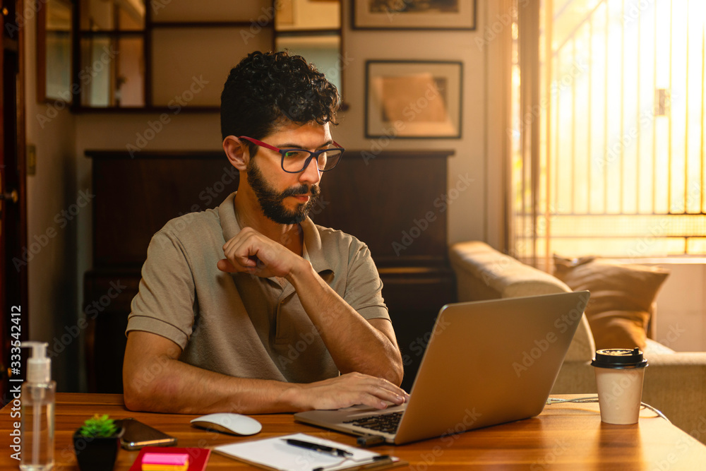 Obraz premium Handsome model with beard at his workplace. Home office concept.