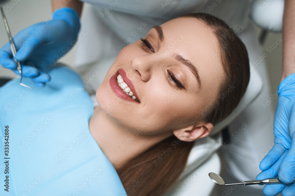 Smiling woman in dental chair stock photo Smiling woman in dental chair stock photo