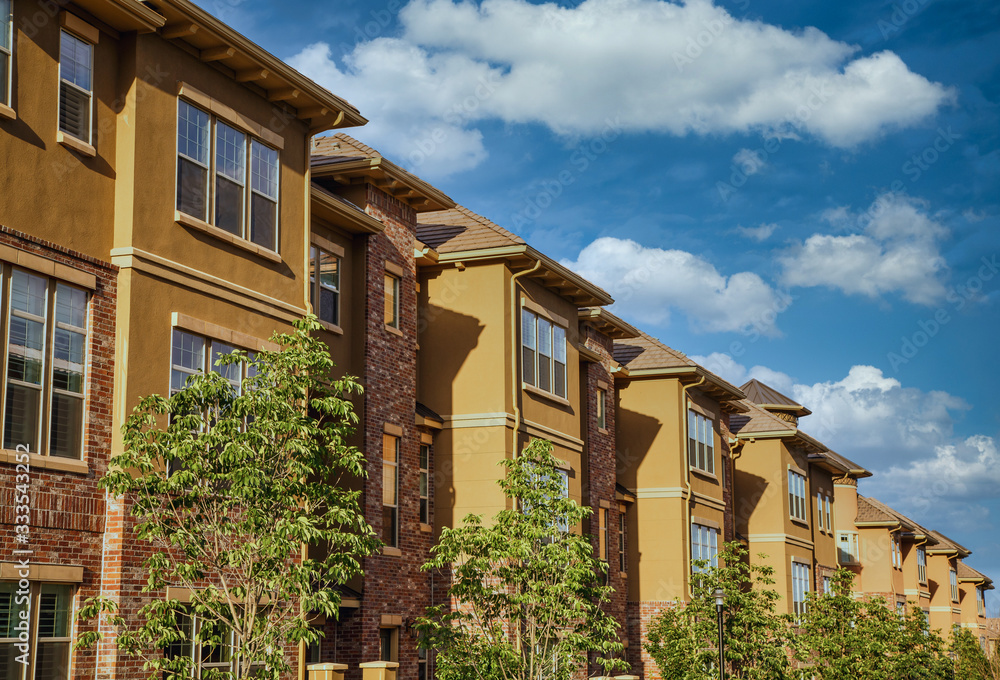 Fototapeta premium Modern Stucco and Brick Condos Under Summer Sky