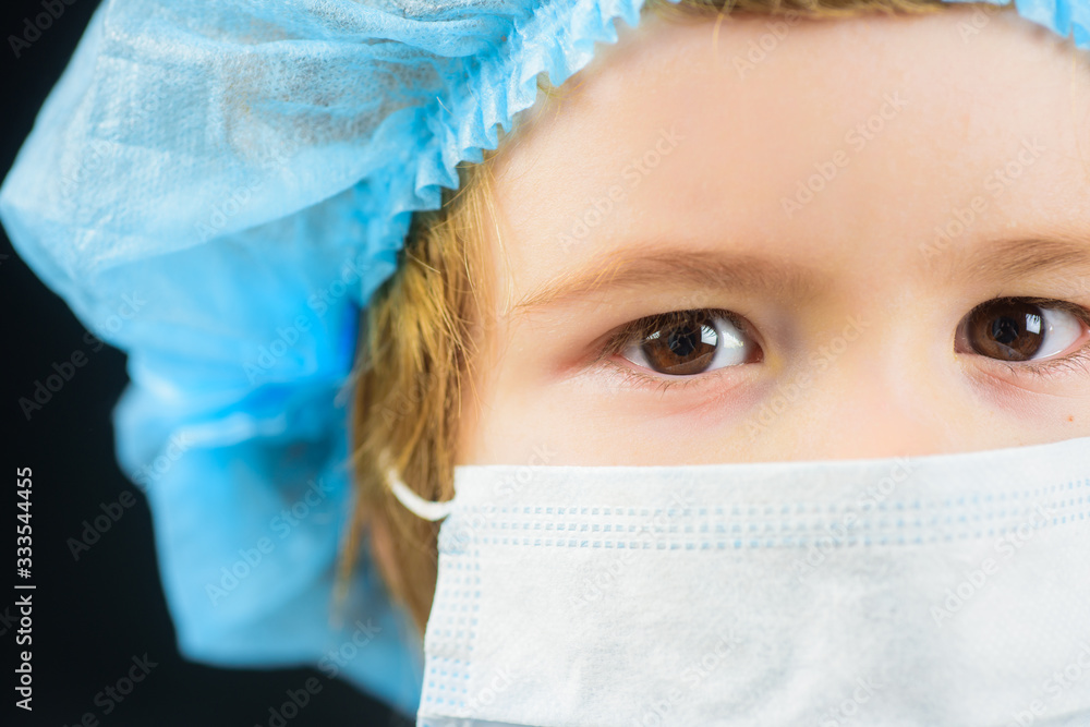 Face mask against virus, ill, epidemic, flu. Child wearing medicine mask. Healthcare concept. Human population virus, infection, flu disease prevention. Boy with protection mask. Coronavirus. Closeup. Face mask against virus, ill, epidemic, flu. Child wearing medicine mask. Healthcare concept. Human population virus, infection, flu disease prevention. Boy with protection mask. Coronavirus. Closeup.