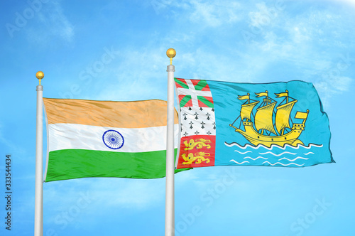 India and Saint Pierre and Miquelon two flags on flagpoles and blue cloudy sky photo