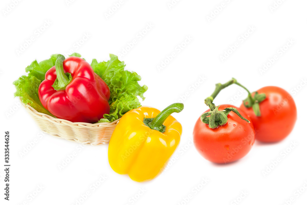 Ripe fresh organic vegetables in a basket and tomatoes on a branch in drops of dew isolated on a white background Ripe fresh organic vegetables in a basket and tomatoes on a branch in drops of dew isolated on a white background