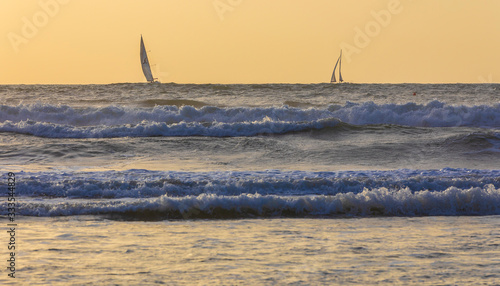 Sailboats sailing in a stor...