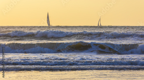 Sailboats sailing in a stor...