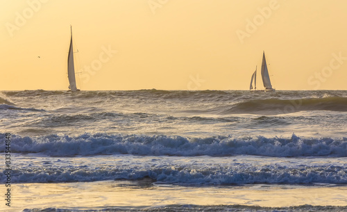 Sailboats sailing in a stor...