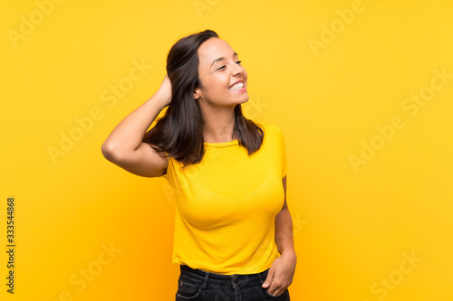 Young brunette girl over isolated background thinking an idea