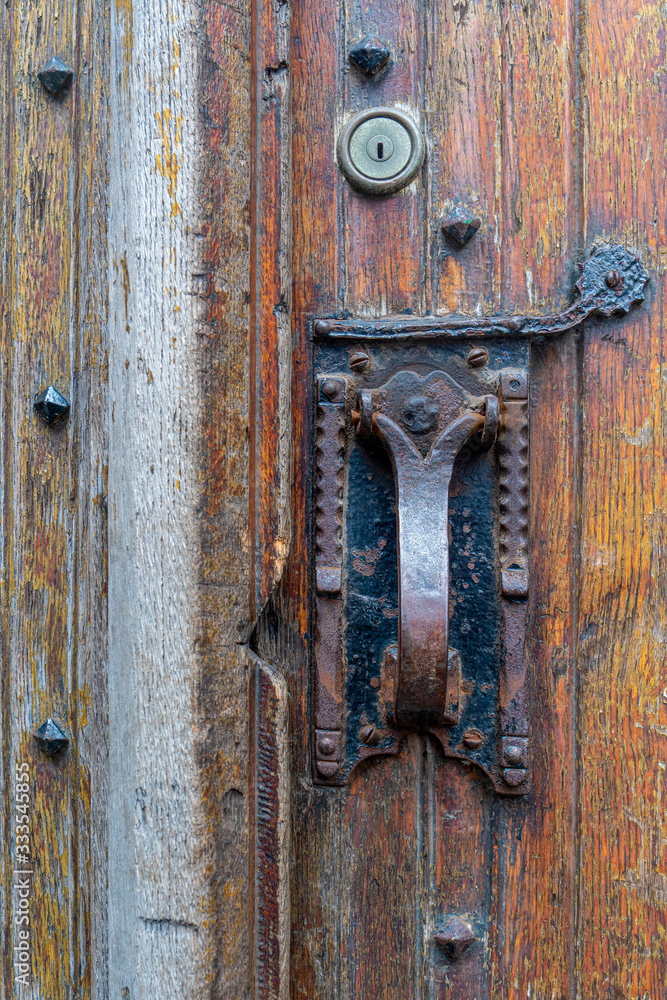 Classic door handle lock on historical door, Ghent, Belgium.