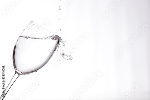 clear liquid pouring into a wine glass