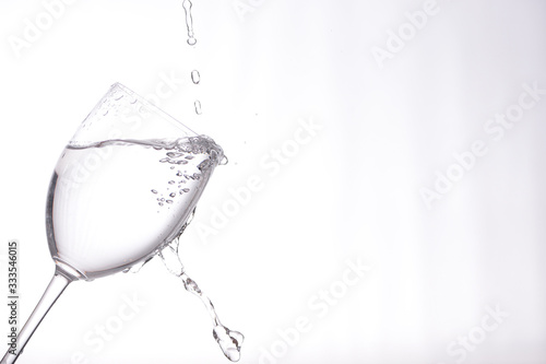 clear liquid pouring into a wine glass