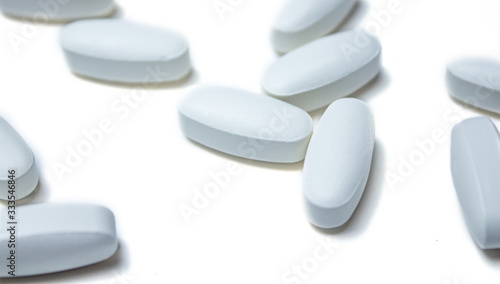 Tablets. Pills background. Pills and tablets in white on a white background. Macro. Copy space