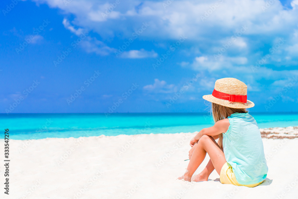 Adorable little girl have fun at tropical beach during vacation Adorable little girl have fun at tropical beach during vacation
