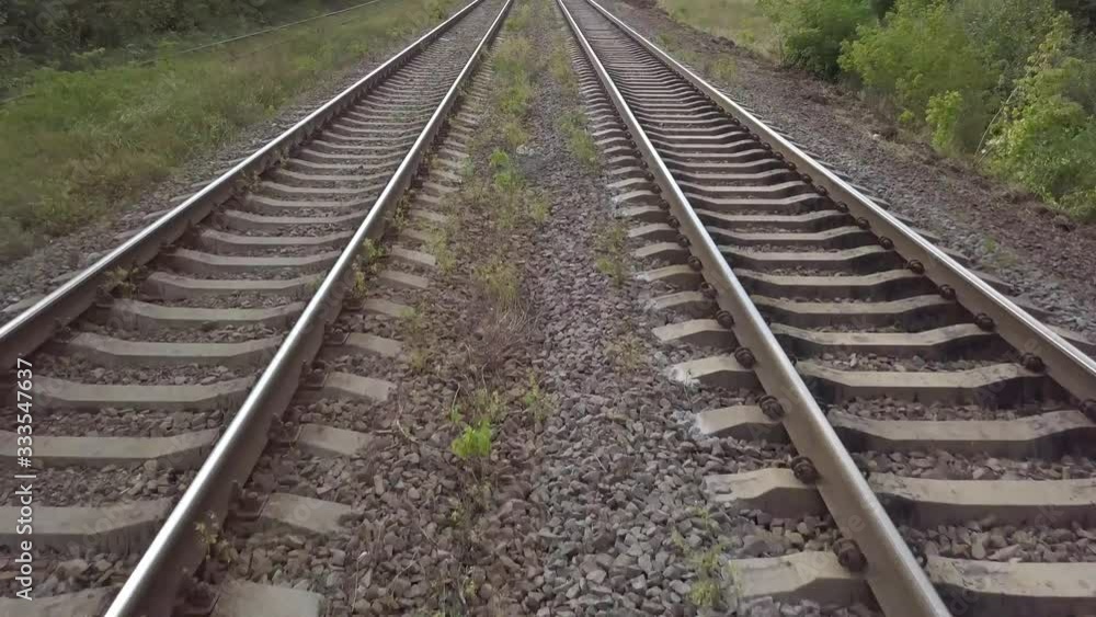 Aerial top view of train rails and drone closed to the rails and going fast Aerial top view of train rails and drone closed to the rails and going fast