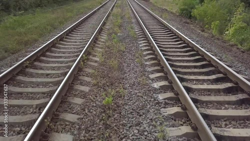 Aerial top view of train rails and drone closed to the rails and going fast