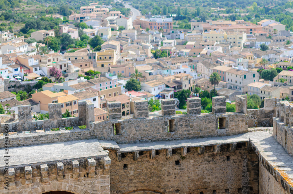 Fortified walls and ramparts at Capdepera Castle with the village down below, Mallorca/Majorca