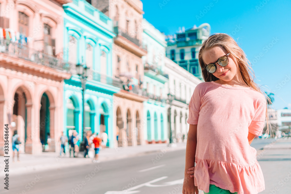 Tourist girl in popular area in Havana, Cuba. Young kid traveler smiling