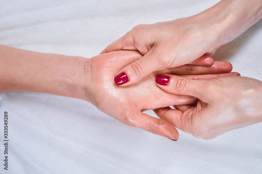 Tender female fingers massaging palm during session