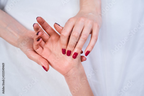 Focused photo on female hands that demonstrating manicure