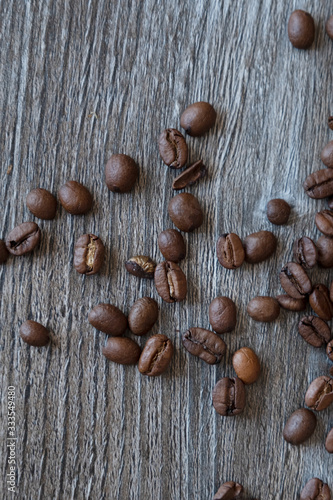 Coffee beans scattered on an open table. View from above.