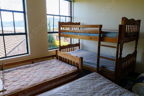 Canvas Print Four beds in a cramped bedroom