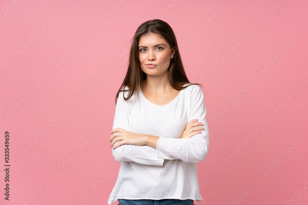 Young woman over isolated pink background feeling upset Young woman over isolated pink background feeling upset