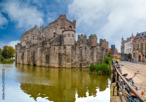 Ghent/Belgium - October 10, 2019: View from the river of the castle of Ghent in Belgium with blue sky and white clouds..