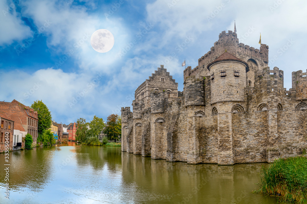 View from the river of the castle of Ghent in Belgium with blue sky and white clouds..