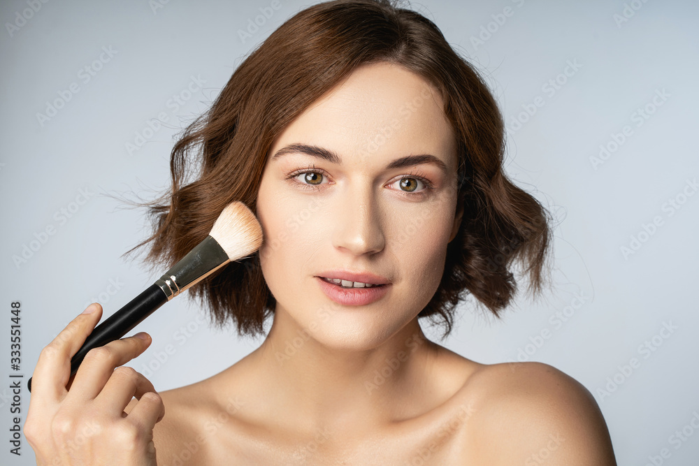 Fototapeta premium Attractive brunette female person testing decorative cosmetics