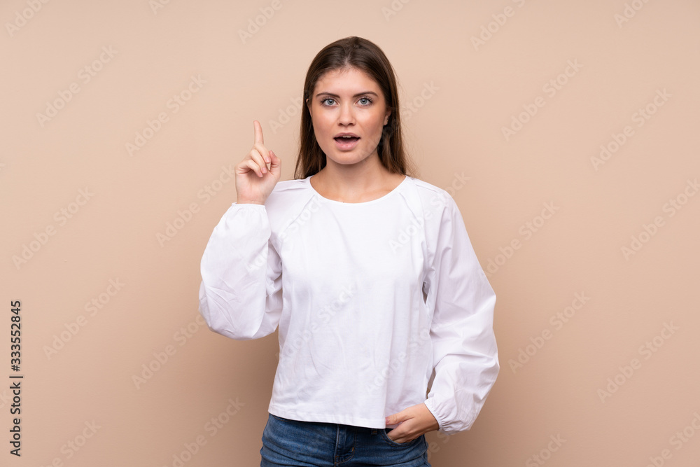 Young girl over isolated background thinking an idea pointing the finger up Young girl over isolated background thinking an idea pointing the finger up