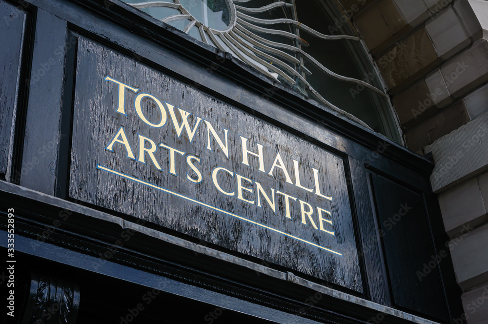 Sign above the door of a former town hall, now an arts centre,