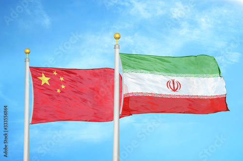 Konstfotografi China and Iran two flags on flagpoles and blue cloudy sky