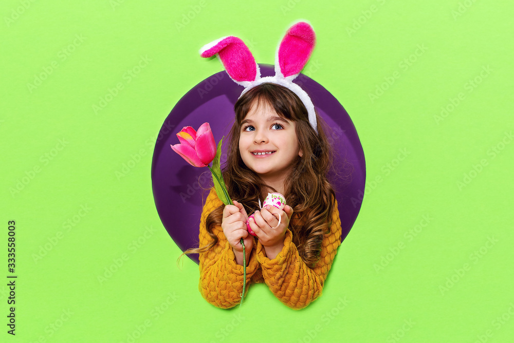 Happy Easter. Funny cheerful little girl in rabbit ears