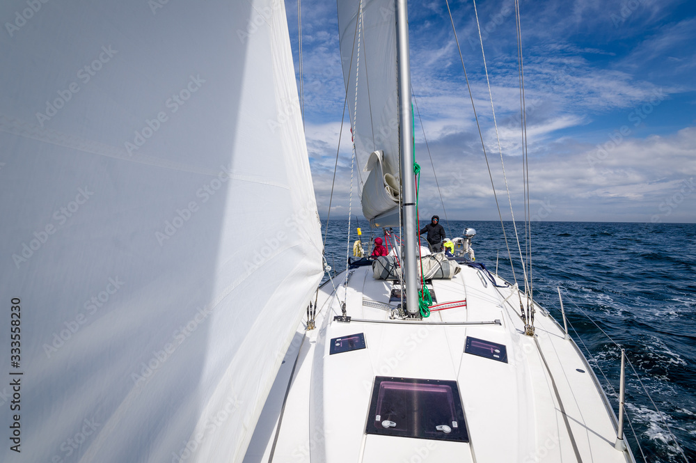 Sailing boat view from the bow, genoa and mainsail hoisted. Inner Hebrides sailing trip, Scotland. Sailing boat view from the bow, genoa and mainsail hoisted. Inner Hebrides sailing trip, Scotland.