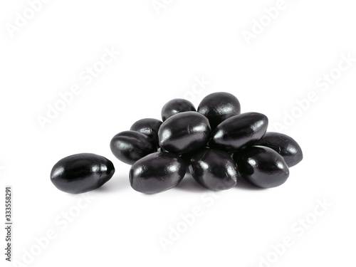Heap of large dried black olives with stone isolated on white background   
