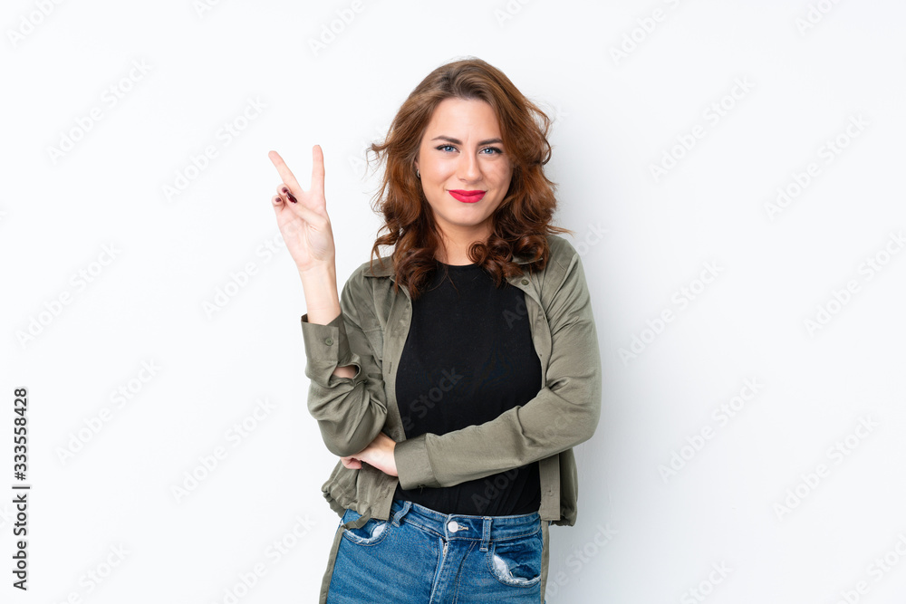 Young Russian woman over isolated white background smiling and showing victory sign Young Russian woman over isolated white background smiling and showing victory sign