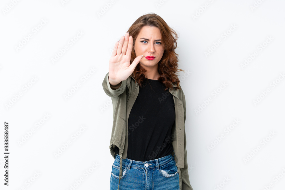 Young Russian woman over isolated white background making stop gesture Young Russian woman over isolated white background making stop gesture
