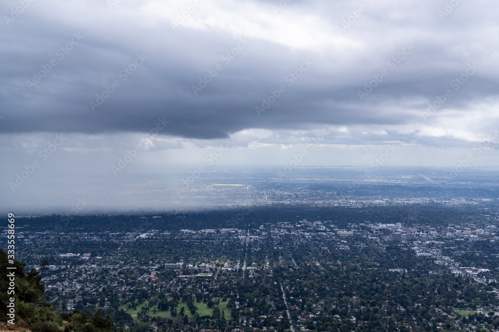Mountaintop view of storm clouds and rain moving into Pasadena in Los Angeles County California.