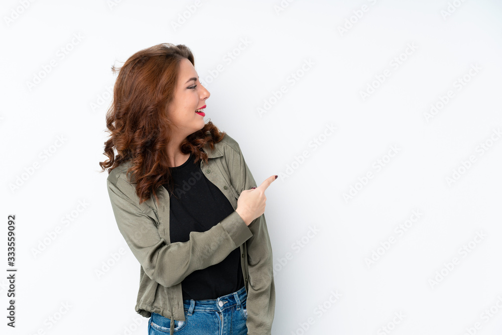 Young Russian woman over isolated white background pointing back Young Russian woman over isolated white background pointing back