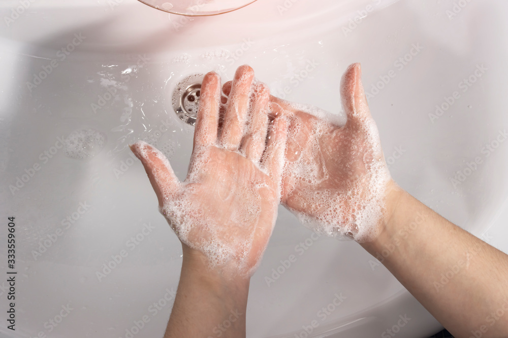 Fototapeta premium Close-up of a girl washing her hands with antibacterial soap. Concept hygiene