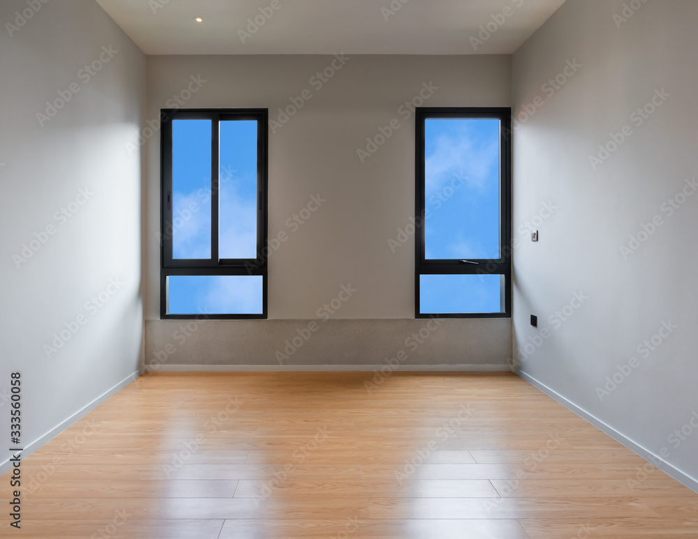 Empty room interior with windows overlooking the blue sky, Beautiful wooden floor and white wall modern office building or home and living architecture Empty room interior with windows overlooking the blue sky, Beautiful wooden floor and white wall modern office building or home and living architecture