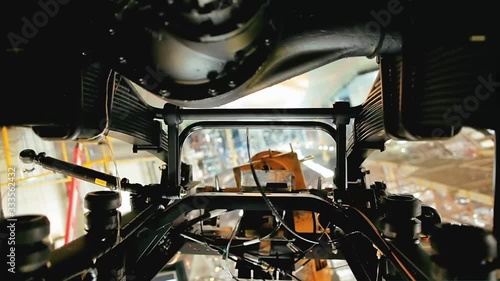 Close up of the process of car assembly at the production line. Stock footage. Rotating detail of the mechanism at the car assembly factory, construction concept. photo