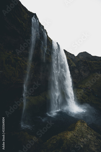 Beautiful Landscape image of a Waterfall in Iceland during dark moody weather 