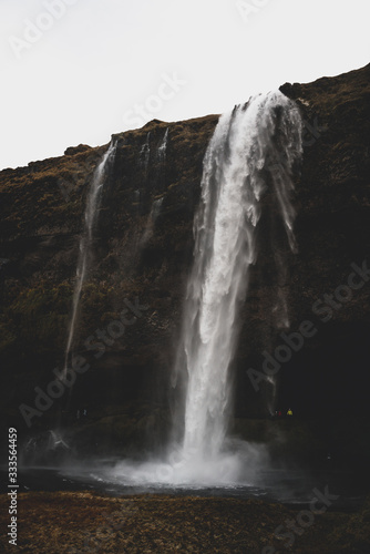 Beautiful Landscape image of a Waterfall in Iceland during dark moody weather 